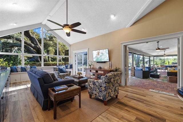 living room with plenty of natural light, wood-type flooring, and a sunroom