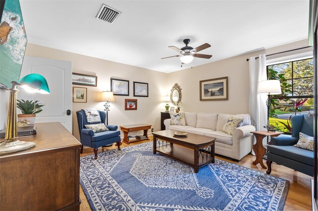 living room featuring ceiling fan, wood finished floors, and visible vents