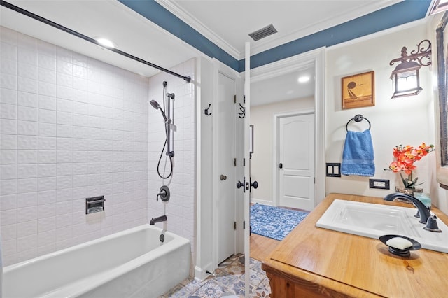 bathroom with ornamental molding, bathing tub / shower combination, vanity, and visible vents