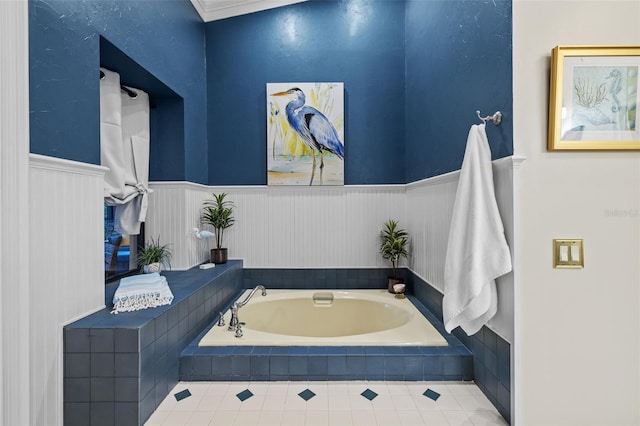 bathroom featuring a garden tub and wainscoting