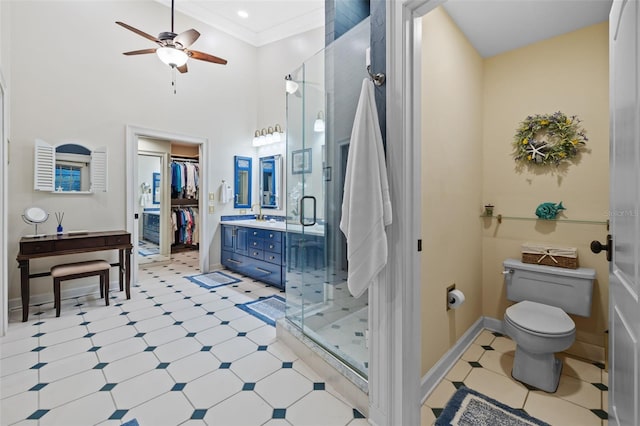 full bathroom featuring a spacious closet, a shower stall, vanity, and tile patterned floors