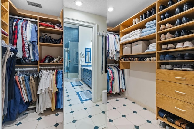 walk in closet featuring visible vents and tile patterned floors