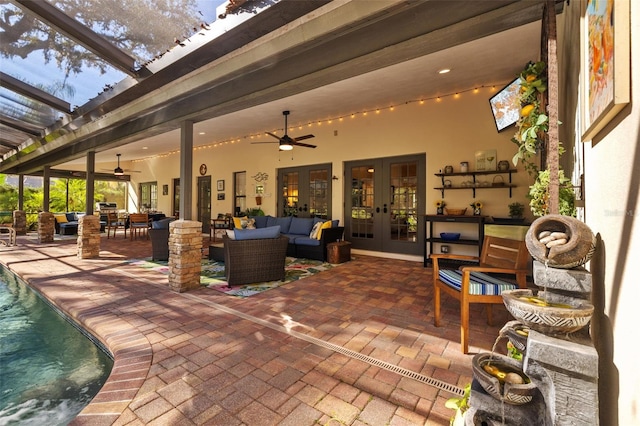 view of patio / terrace featuring french doors, an outdoor hangout area, outdoor dining space, ceiling fan, and an outdoor pool