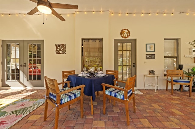 interior space featuring french doors, brick floor, and a ceiling fan