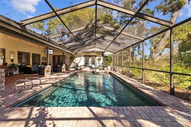 pool featuring ceiling fan, a lanai, an outdoor hangout area, french doors, and a patio area