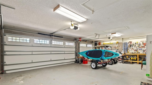 garage with a garage door opener and a workshop area