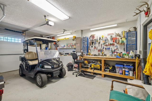 garage featuring a garage door opener and a workshop area