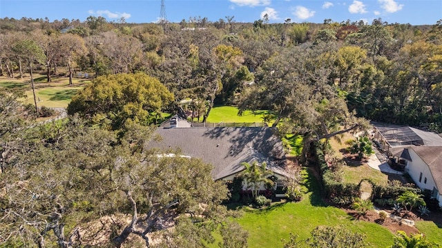 birds eye view of property with a view of trees