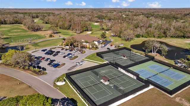 bird's eye view featuring a water view, view of golf course, and a view of trees