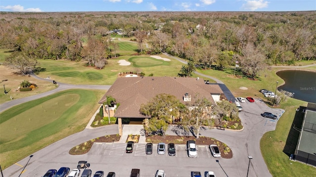 bird's eye view with view of golf course, a water view, and a wooded view