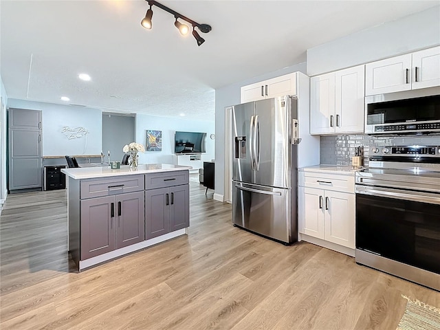 kitchen featuring appliances with stainless steel finishes, white cabinets, and gray cabinets