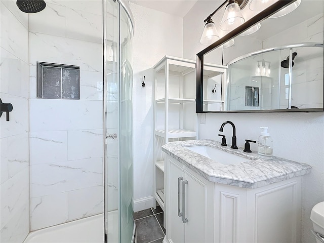 bathroom with tile patterned floors, a shower with shower door, and vanity