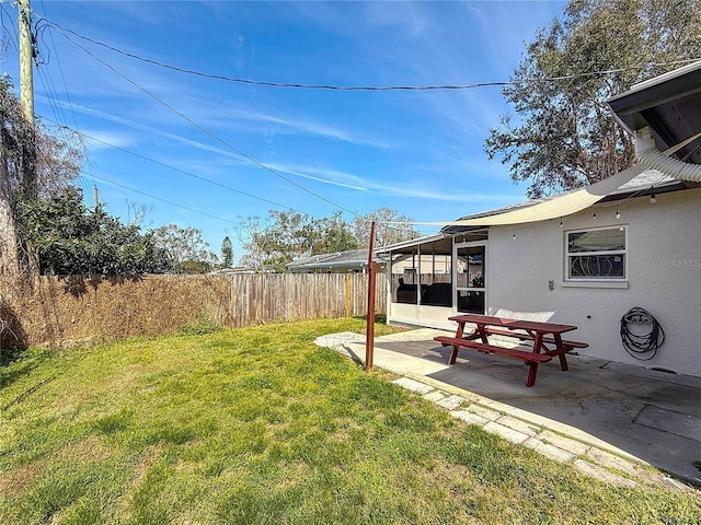 view of yard featuring a patio and a sunroom