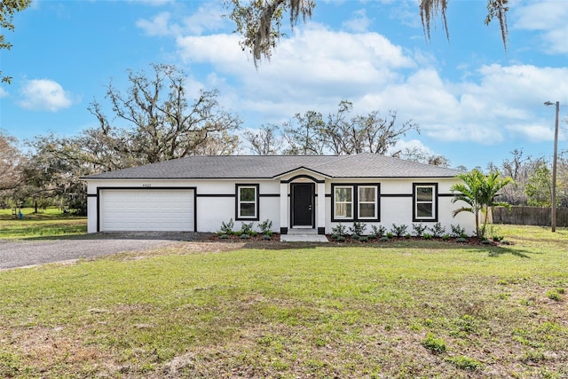 single story home with gravel driveway, a front lawn, fence, stucco siding, and an attached garage