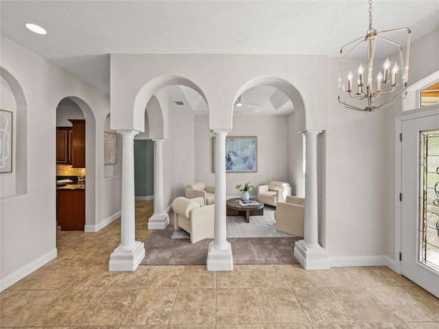 foyer entrance featuring ornate columns and light tile patterned flooring