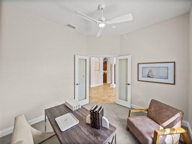 office space with french doors, light carpet, and ceiling fan