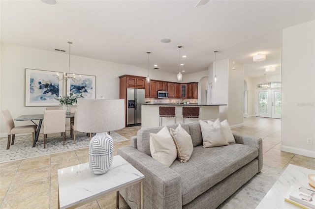 living room with light tile patterned floors and a notable chandelier