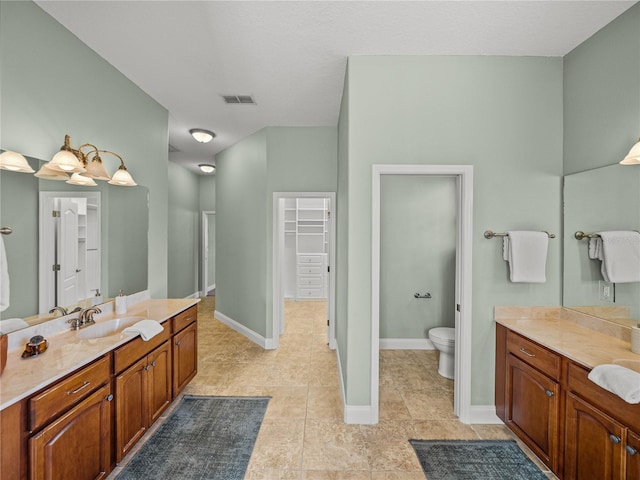 bathroom featuring toilet and vanity