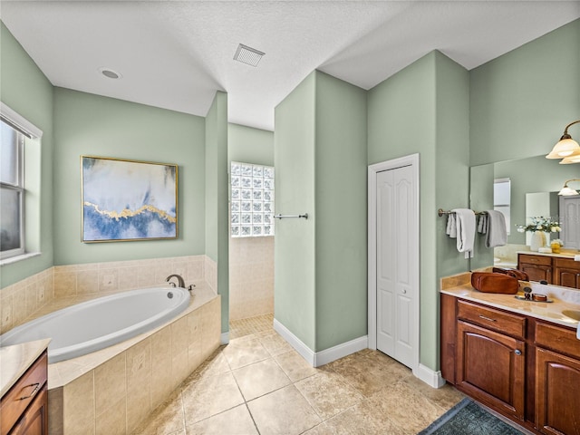 bathroom featuring shower with separate bathtub, tile patterned floors, and vanity