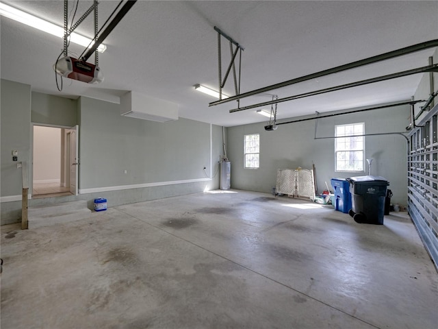 garage featuring a garage door opener and water heater