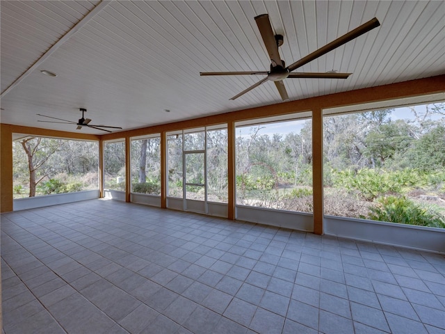 unfurnished sunroom with ceiling fan