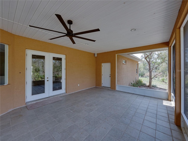 unfurnished sunroom featuring french doors and ceiling fan