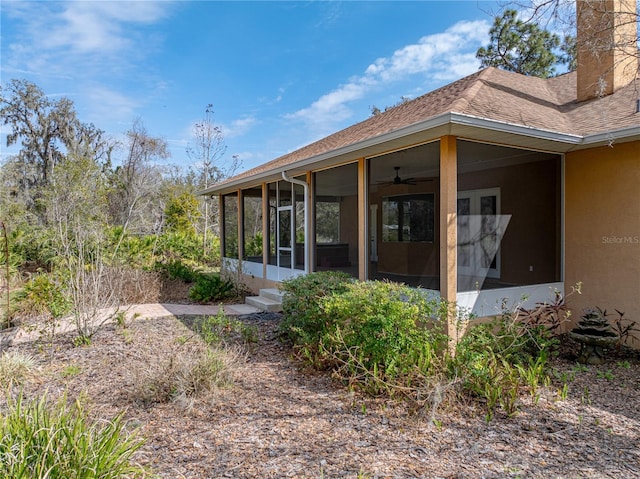 rear view of house featuring a sunroom