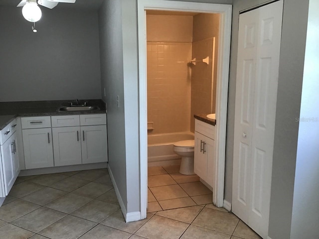 full bathroom featuring baseboards, toilet, tile patterned floors, vanity, and a closet
