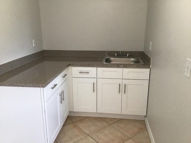 bathroom featuring tile patterned flooring and a sink