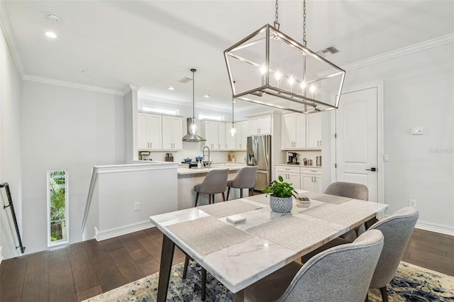 dining area featuring ornamental molding and dark wood-type flooring