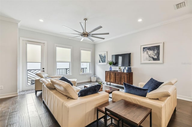 living room featuring crown molding, dark wood-type flooring, and ceiling fan