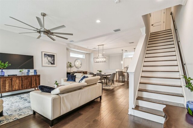 living room with ceiling fan, crown molding, and dark hardwood / wood-style flooring