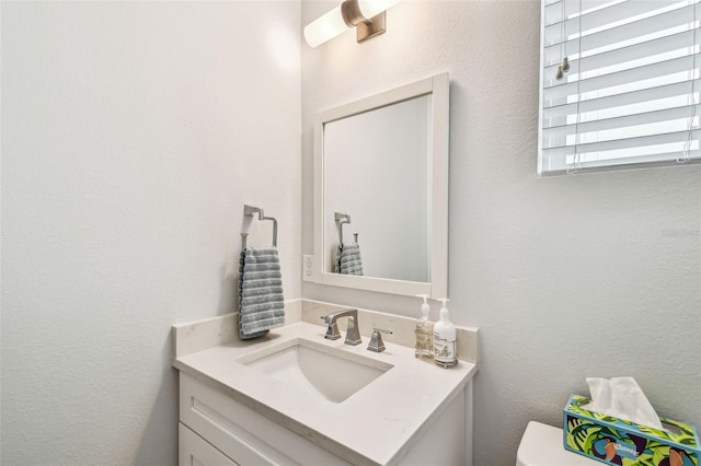 bathroom featuring toilet and vanity