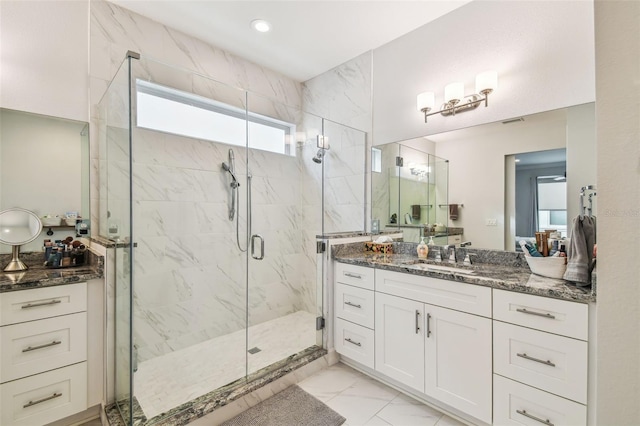 bathroom featuring an enclosed shower and vanity