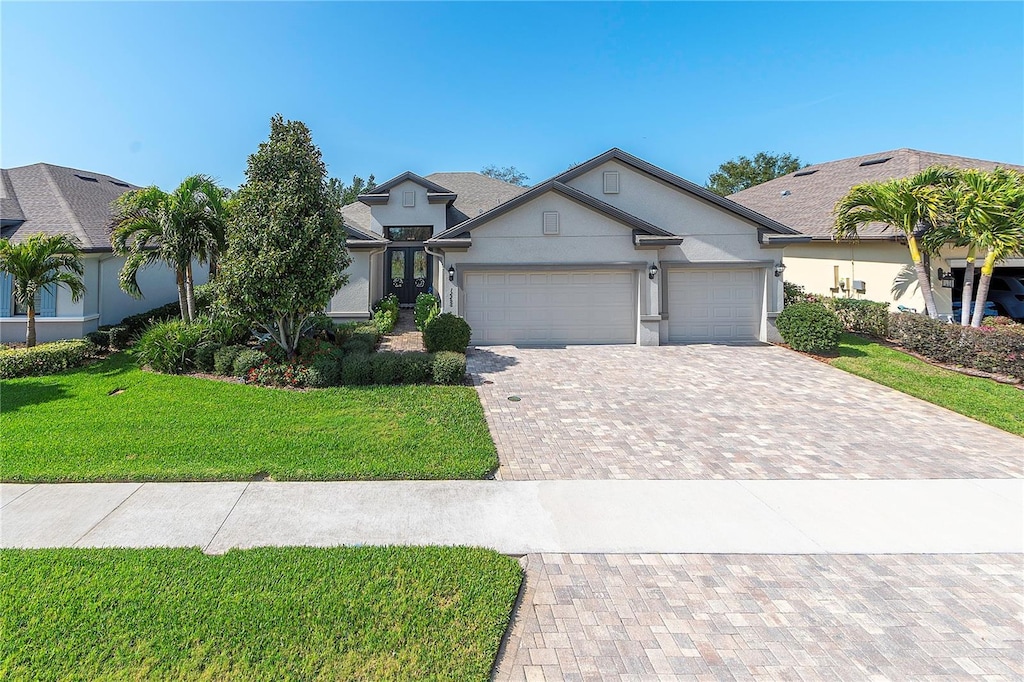 view of front of home featuring a garage and a front lawn