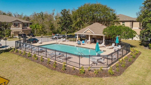 view of swimming pool with a patio and a yard