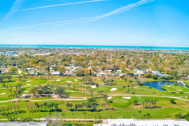 drone / aerial view featuring view of golf course and a water view