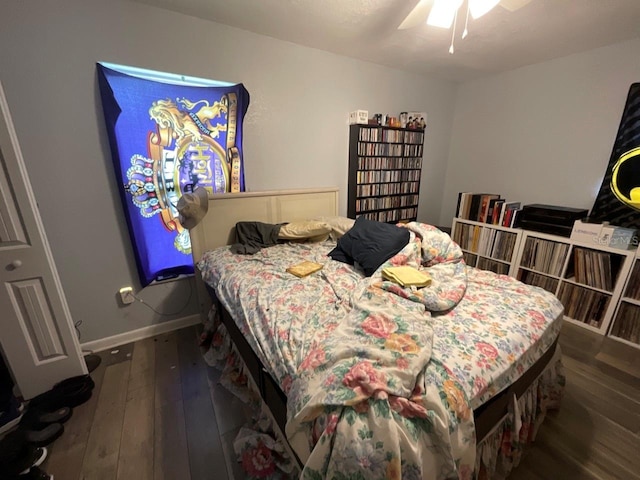 bedroom featuring dark wood-type flooring, a ceiling fan, and baseboards