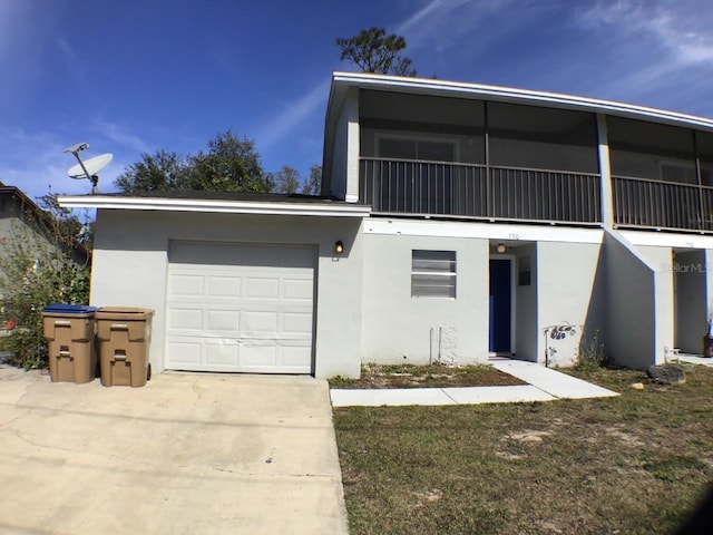 view of front facade with driveway, an attached garage, and stucco siding