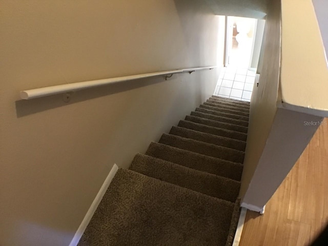 stairway featuring baseboards