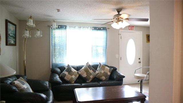 living room with a textured ceiling and ceiling fan