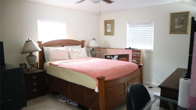 tiled bedroom featuring ceiling fan