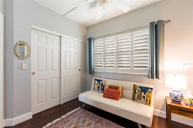 interior space with dark wood-type flooring, a ceiling fan, and baseboards