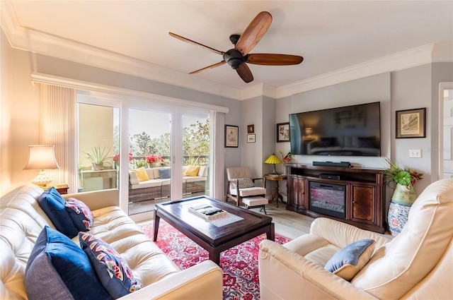 living room with a ceiling fan, light wood-type flooring, and crown molding