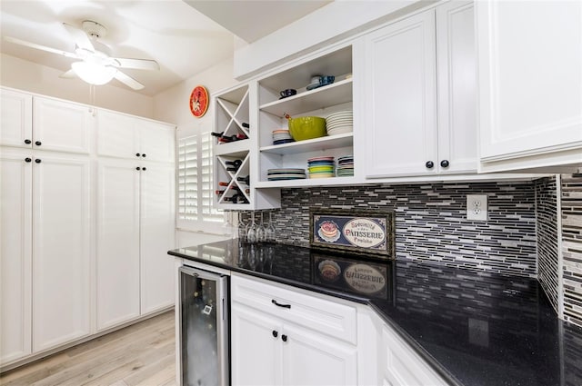 kitchen featuring beverage cooler, white cabinetry, and open shelves