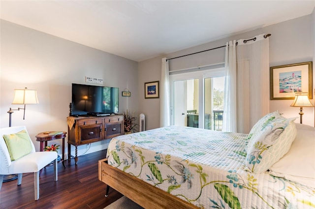 bedroom with access to exterior and dark wood-style floors