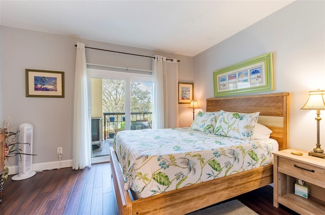 bedroom featuring dark wood-style floors, access to outside, and baseboards