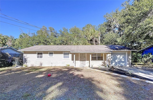 ranch-style house featuring driveway and an attached garage