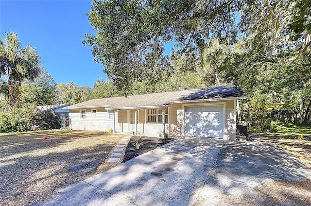 ranch-style home featuring covered porch, concrete driveway, and an attached garage