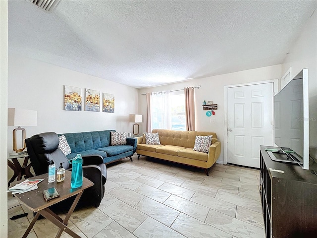 living room featuring visible vents and a textured ceiling